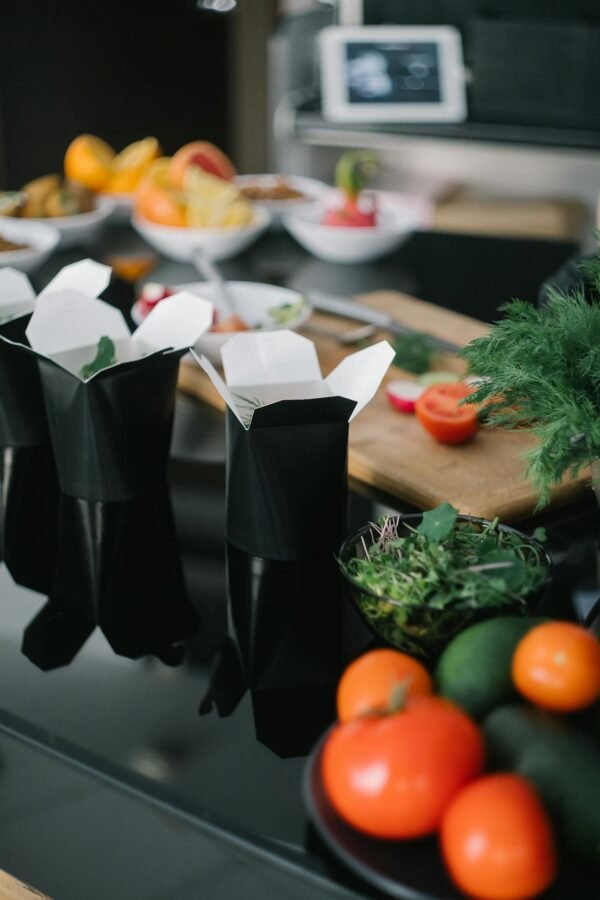 A selection of fresh vegetables and takeout boxes for a healthy meal option.